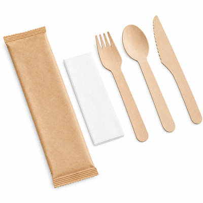 Wooden cutlery set with brown kraft paper sleeve, white napkin, fork, spoon and knife